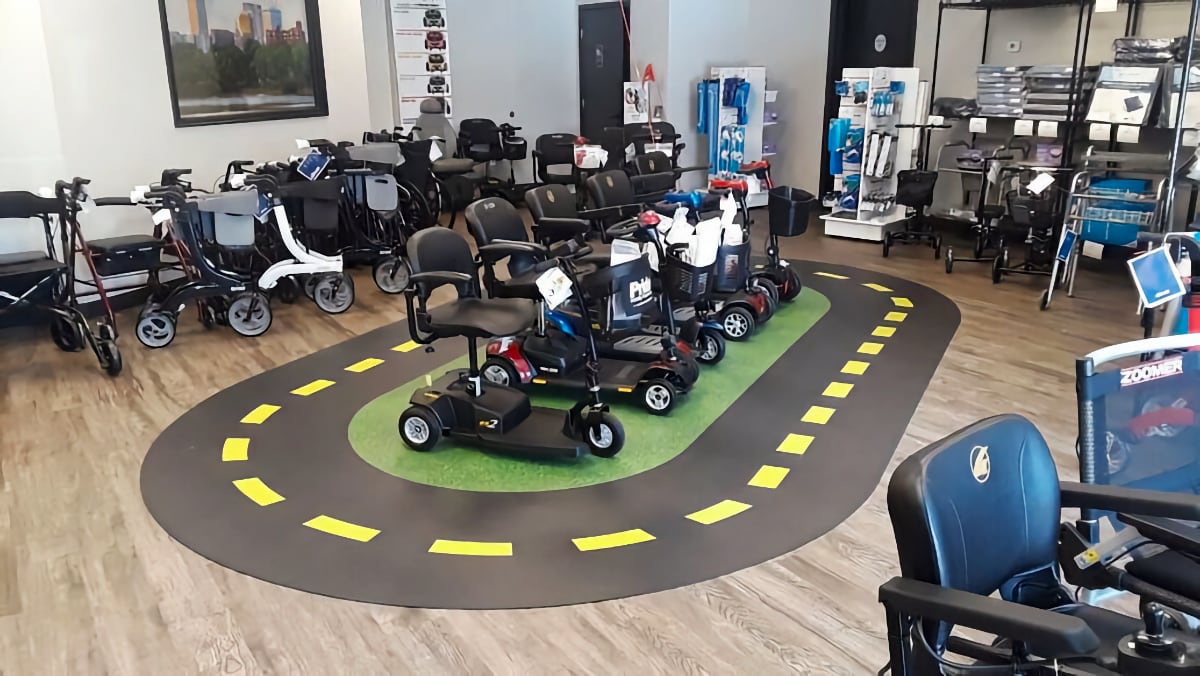 T-Town Mobility showroom with various scooter and mobility products and a racetrack