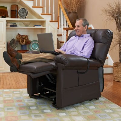 older man working on a laptop while reclined in his lift chair