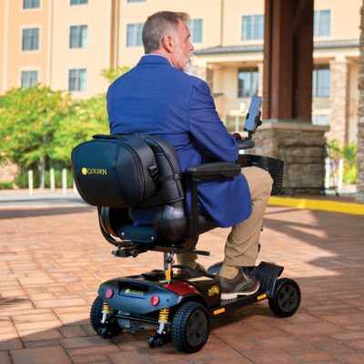 business man sitting in Golden mobility scooter with cell phone attached